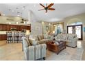 Open floor plan living room with adjacent kitchen and breakfast bar at 1131 Via Tripoli, Punta Gorda, FL 33950