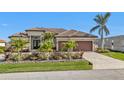 Single-Gathering home with two-car garage and tropical landscaping at 1220 Spanish Cay Ln, Punta Gorda, FL 33950