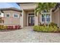 Front entrance with double doors and a brick walkway at 1220 Spanish Cay Ln, Punta Gorda, FL 33950