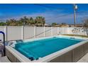 Inviting backyard pool with gray coping and a white vinyl fence at 1236 Fleetwood Nw Dr, Port Charlotte, FL 33948