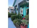 House entrance with teal accents and lush landscaping at 1281 Nebraska Ln, North Port, FL 34286