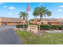 Conquistador Landing community entrance with palm trees and covered parking at 1348 Rock Dove Ct # C103, Punta Gorda, FL 33950