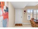 Bright condo entryway with white door and colorful artwork at 1348 Rock Dove Ct # C103, Punta Gorda, FL 33950