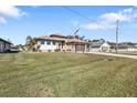 House with a large yard, showcasing curb appeal at 143 Uruguay Dr, Punta Gorda, FL 33983