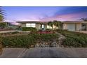 House exterior at dusk, featuring landscaping and a teal door at 162 Croop Se Ln, Port Charlotte, FL 33952