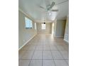 Spacious living room featuring tile floors and ceiling fan at 21061 Midway Blvd, Port Charlotte, FL 33952