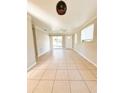 Bright living room with tile floors and sliding glass doors at 21061 Midway Blvd, Port Charlotte, FL 33952