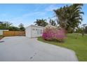 White single story home with a spacious front yard and tropical plants at 4500 Nutsedge Rd, Port Charlotte, FL 33953