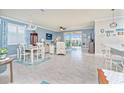 Open concept living area with light tile floors and coastal decor at 6139 Grand Cypress Blvd, North Port, FL 34287