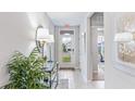 Bright and airy entryway with tiled floors and modern decor at 9578 Turtle Grass Cir, Punta Gorda, FL 33950