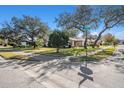 An aerial view showcasing a home nestled amongst mature trees in a residential area at 10810 Cedar Breaks Dr, Port Richey, FL 34668