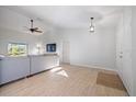 Bright living room featuring a sectional sofa and wood-look floors at 11346 Laffite Pl, Port Charlotte, FL 33981