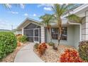 Landscaped front yard with a walkway leading to the screened entryway at 157 Valdiva St, Punta Gorda, FL 33983