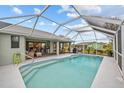 Relaxing pool area with screened enclosure and patio furniture at 157 Valdiva St, Punta Gorda, FL 33983