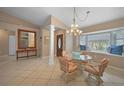 Bright dining area with a glass table, wicker chairs, and built in cabinetry at 16161 Juarez Cir, Punta Gorda, FL 33955