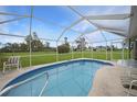 Relaxing pool area with a screened enclosure and lush green surroundings at 16161 Juarez Cir, Punta Gorda, FL 33955