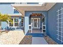 Inviting front entryway with a white door and porch at 18500 Ohara Dr, Port Charlotte, FL 33948