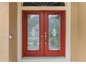 Double red front doors with etched glass panels at 201 Champion St, Port Charlotte, FL 33953