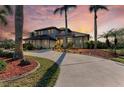 Two-story home with palm trees and a circular driveway at 21391 Harborside Blvd, Port Charlotte, FL 33952