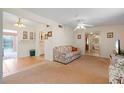 Bright living room with floral couches and tiled floors at 217 W Tarpon Nw Blvd, Port Charlotte, FL 33952