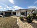 Side view of a single story home with well-manicured landscaping at 2219 Bengal Ct, Punta Gorda, FL 33983