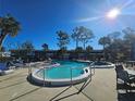 Community pool with lounge chairs and surrounding landscaping at 2290 Aaron St # 302, Port Charlotte, FL 33952