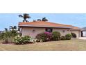 Brick house with lush landscaping, tile roof, and attractive facade at 310 Belvedere Ct, Punta Gorda, FL 33950