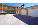 Condo building with two-car garage and paved courtyard at 3216 Purple Martin Dr # 123, Punta Gorda, FL 33950