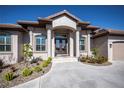 Front entrance of the home, showcasing columns, double doors, and meticulously maintained landscaping at 4037 Bal Harbor Blvd, Punta Gorda, FL 33950