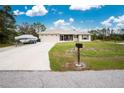 Landscaped lawn and a two-car garage. Boat parked in driveway at 6104 Plamendon Ave, North Port, FL 34291