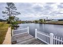 Private dock with a wooden deck and white fence at 6365 Scorpio Ave, North Port, FL 34287