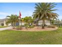 Landscaped front yard with palm trees and well-maintained lawn at 7424 S Moss Rose, Punta Gorda, FL 33955