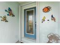 Front door entry with eclectic decor and blue door at 840 Via Tunis, Punta Gorda, FL 33950