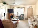 Bright living room featuring a sofa, armchairs, and a fireplace at 8541 Regency Ct, North Port, FL 34287