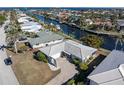 Bird's eye view of a canal-front property showcasing the home and neighborhood at 88 Sabal Dr, Punta Gorda, FL 33950