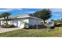 View of the home's side, showcasing the garage and fenced yard at 10454 Waterford Ave, Englewood, FL 34224