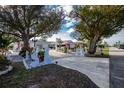 Statues and lush landscaping highlight this home's curb appeal at 115 Sw Seville Sw Pl, Port Charlotte, FL 33952