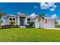 Beautiful two-story home with a metal roof, lush landscaping, and driveway at 1380 Willet Ct, Punta Gorda, FL 33950