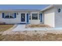 Front entrance with blue shutters and walkway at 143 Rotonda Cir, Rotonda West, FL 33947