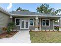 Front entrance with double doors and a walkway leading to the house at 16305 Branco Dr, Punta Gorda, FL 33955