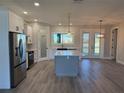 Modern kitchen with stainless steel appliances and a large island at 16305 Branco Dr, Punta Gorda, FL 33955