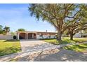 Ranch style home with mature oak trees and driveway at 2544 Warne St, Port Charlotte, FL 33952