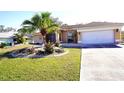 Single-story home with landscaped yard and attached garage at 2812 Cabaret St, Port Charlotte, FL 33948