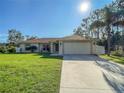 One-story home featuring a large yard and attached garage at 2970 Cascabel Ter, North Port, FL 34286