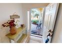 Inviting entryway with decorative console table and a view to a patio at 317 Monaco Dr # 7, Punta Gorda, FL 33950