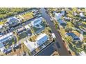 Aerial view of waterfront home featuring a metal roof, private dock, and canal access for boating at 4297 Nettle Rd, Port Charlotte, FL 33953