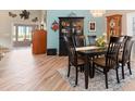 Elegant dining room with hardwood floors, a six-chair table and a view into the living room at 616 Cherrywood Dr, Englewood, FL 34223