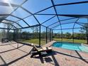 Screened-in pool area with lounge chair and spacious backyard at 8117 Thruso Rd, Port Charlotte, FL 33981