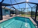 Relaxing screened-in pool with paved patio and lounge chair at 8117 Thruso Rd, Port Charlotte, FL 33981