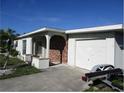 House exterior showcasing a brick facade and attached garage at 120 Rodgers Ne Ave, Port Charlotte, FL 33952